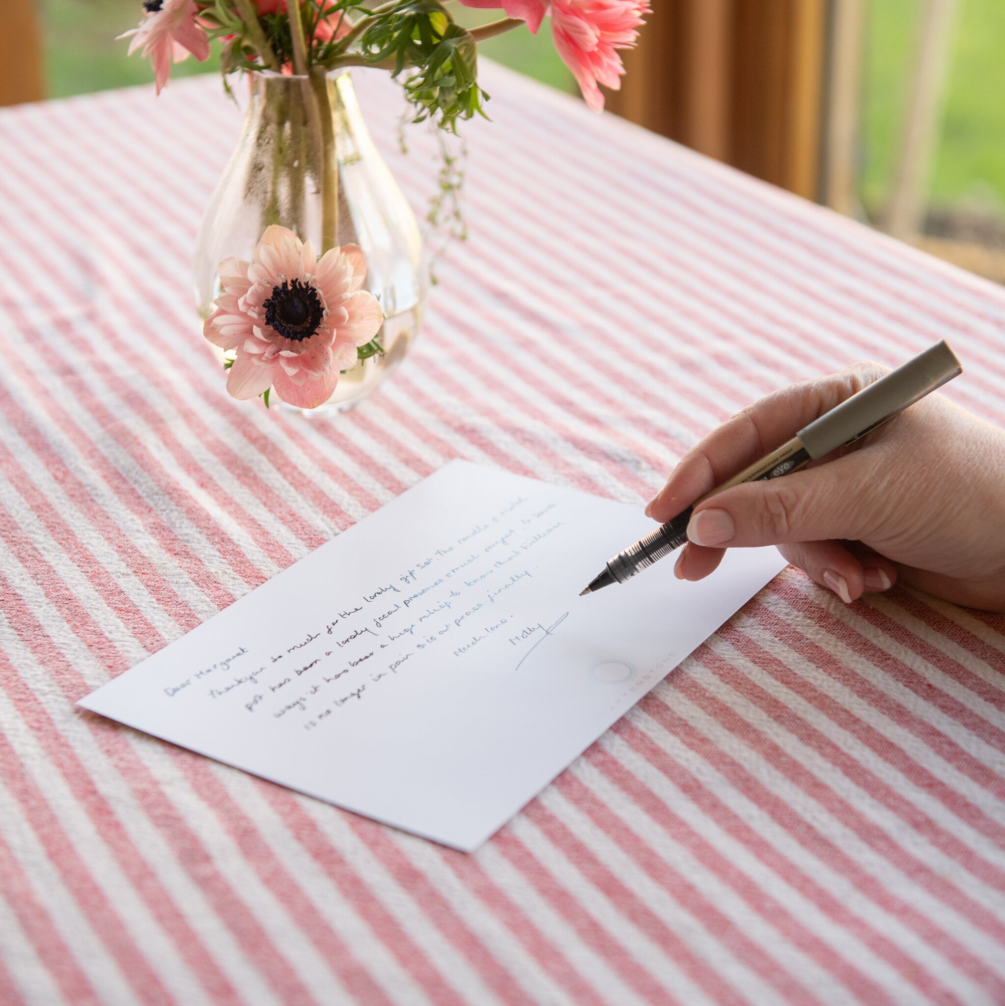hand writing a thankyou note post a celebration of life